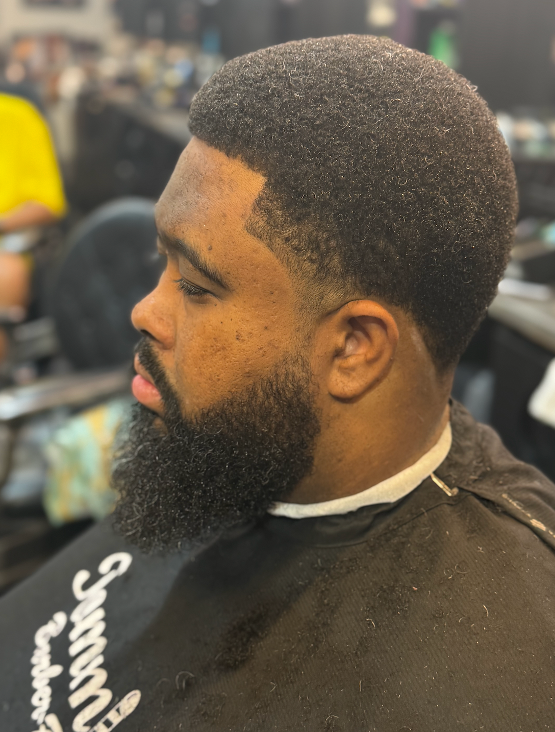 Full beard with clean fade at Tommie's Barber-Beauty