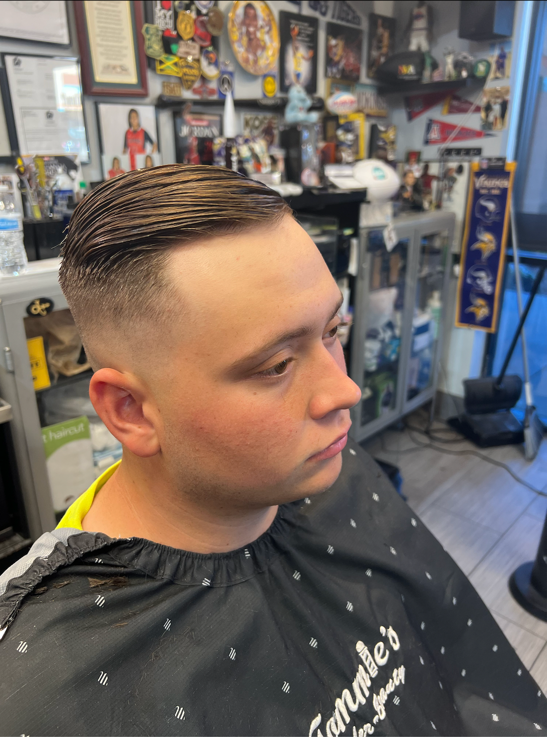 Slick back fade haircut at Tommie's Barber-Beauty
