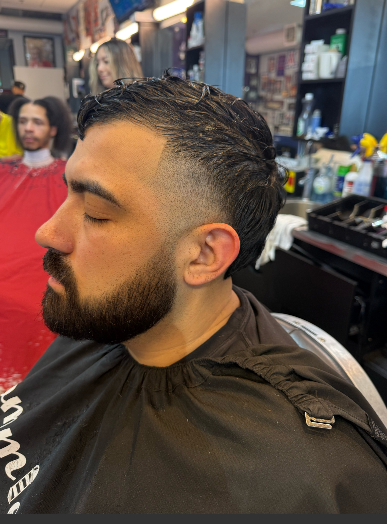 Wavy hair fade with beard trim at Tommie's Barber-Beauty